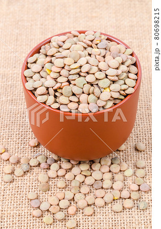 Brown Lentils in cup. 80698215