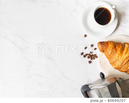 Flat lay frame of cups of coffee and croissant on marble background Flat lay frame of cups of coffee and croissant on marble background 80699207