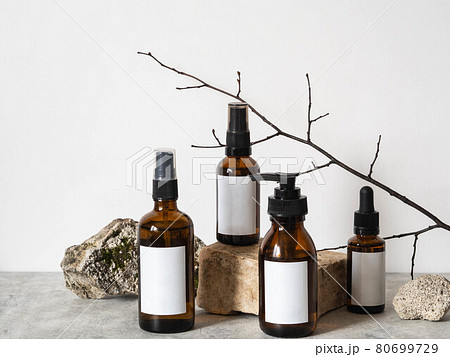 Brown bottles mockup for cosmetic products on natural scenery. 80699729
