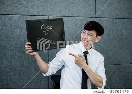 Back to school. Asian male students, holding blackboard labeled Back to School. College male Back to School after Pandemic Coronavirus Disease 2019 80701479