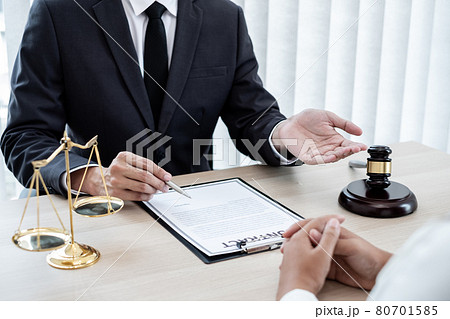 A male lawyer or a judge counseling clients about judicial justice and prosecution with scales, judges gavel, legal documents legal services concept A male lawyer or a judge counseling clients about judicial justice and prosecution with scales, judges gavel, legal documents legal services concept 80701585