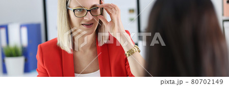 Two businesswoman chatting at working table closeup 80702149