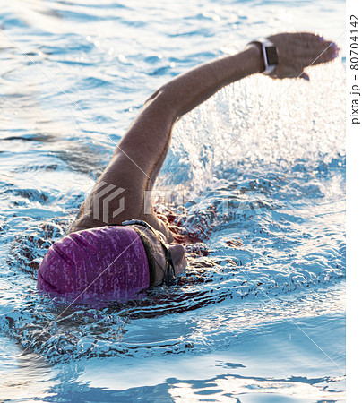 Front view of a women swimming in a pool close up Front view of a women swimming in a pool close up 80704142