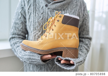 New womens leather brown waterproof hiking winter autumn boots in hands of female New womens leather brown waterproof hiking winter autumn boots in hands of female 80705898