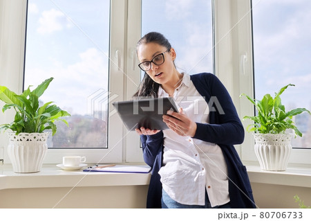 Serious business woman talking on video call, using digital tablet 80706733