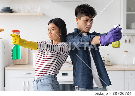 Attractive asian man and woman house-keepers enjoying cleaning Attractive asian man and woman house-keepers enjoying cleaning 80706734
