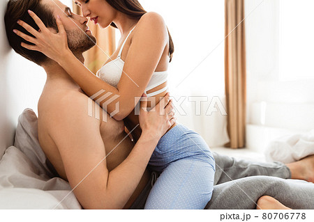 Young Lovers Kissing Enjoying Intimacy Sitting In Bed Indoors Young Lovers Kissing Enjoying Intimacy Sitting In Bed Indoors 80706778