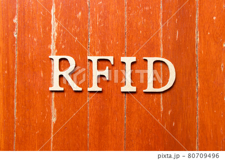 Alphabet letter in word RFID (Abbreviation of Radio-frequency identification) on old red color wood plate background Alphabet letter in word RFID (Abbreviation of Radio-frequency identification) on old red color wood plate background 80709496