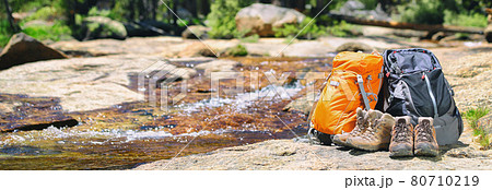 Hiking gear banner background in summer forest two backpacks and trek shoes boots for hikers couple camping travel outdoor adventure panoramic header Hiking gear banner background in summer forest two backpacks and trek shoes boots for hikers couple camping travel outdoor adventure panoramic header 80710219