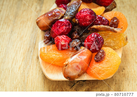 Varieties of dried fruits on wooden spoon. Varieties of dried fruits on wooden spoon. 80710777
