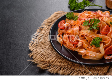 Fettuccine pasta with shrimp, cherry tomatoes, sauce, spices and herbs Fettuccine pasta with shrimp, cherry tomatoes, sauce, spices and herbs 80710975