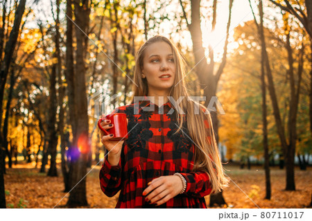 Vitamin D in autumn and winter season. Vitamin D in Womens Health, Role of Vitamin D3 Supplements in female health. Young woman enjoying sun in fall nature background Vitamin D in autumn and winter season. Vitamin D in Womens Health, Role of Vitamin D3 Supplements in female health. Young woman enjoying sun in fall nature background 80711017