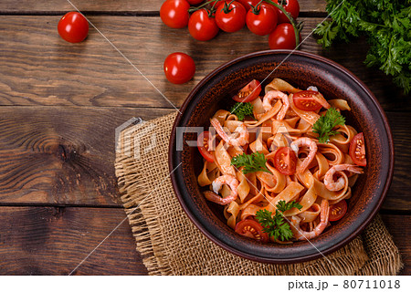 Fettuccine pasta with shrimp, cherry tomatoes, sauce, spices and herbs Fettuccine pasta with shrimp, cherry tomatoes, sauce, spices and herbs 80711018