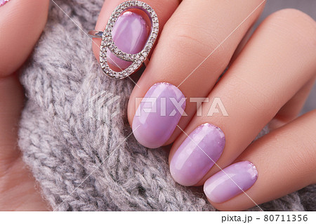 Womans hand with fashionable lavender manicure. Winter christmas nail design 80711356