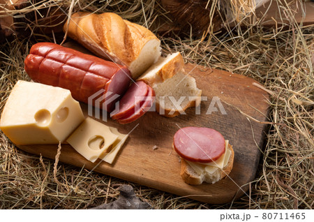 Meat and cheese cuts. Homemade cheese and meat. Rustic style. Variety of cheese and meats on a cutting board. 80711465