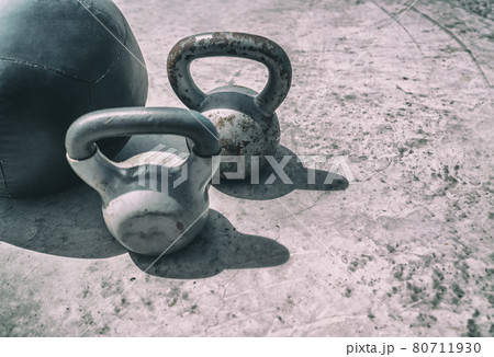 Fitness kettlebells weights gym background. Free kettlebell weight and medicine ball training workout outdoor place. Kettlebells heavy weight for weightlifting cross training Fitness kettlebells weights gym background. Free kettlebell weight and medicine ball training workout outdoor place. Kettlebells heavy weight for weightlifting cross training 80711930