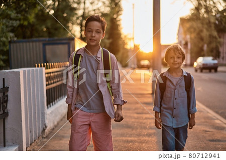 School boys running to school. School boys having fun after school. 80712941