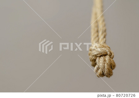 Jute rope hanging from above with knots. Jute rope hanging from above with knots. 80720726