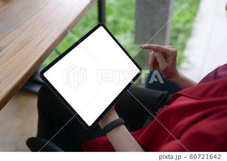 Businesswoman using digital tablet while sitting at office. 80721642