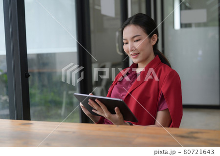 Successful businesswoman using digital tablet at office. 80721643