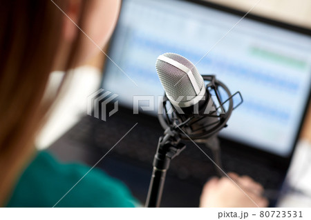 woman with microphone recording podcast at studio woman with microphone recording podcast at studio 80723531