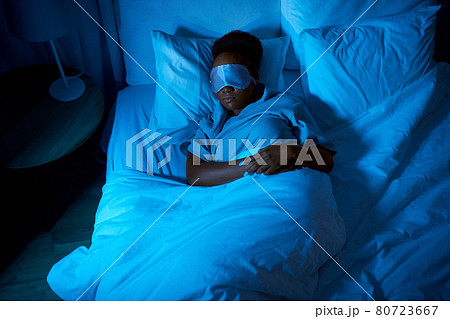 african woman sleeping in bed at home at night african woman sleeping in bed at home at night 80723667