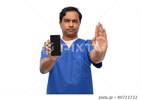 indian male doctor with phone showing stop gesture indian male doctor with phone showing stop gesture 80723722