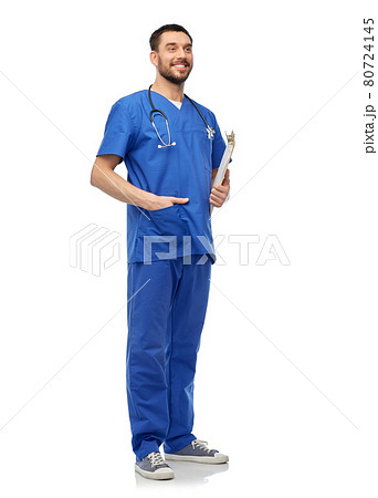 smiling doctor in blue uniform with clipboard smiling doctor in blue uniform with clipboard 80724145