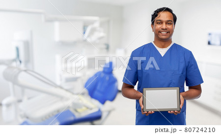 doctor or male dentist showing tablet computer 80724210