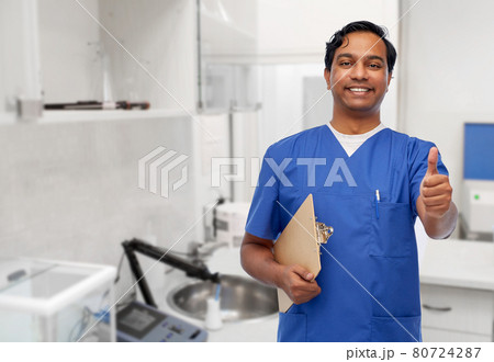 smiling doctor or male nurse showing thumbs up smiling doctor or male nurse showing thumbs up 80724287