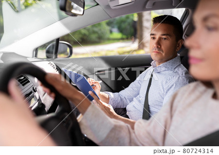 car driving school instructor and young driver 80724314