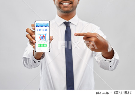 man with certificate of vaccination on smartphone man with certificate of vaccination on smartphone 80724922
