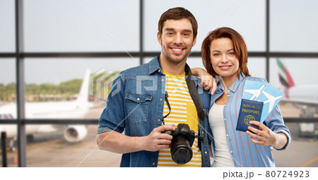 couple with tickets, immunity passport and camera 80724923