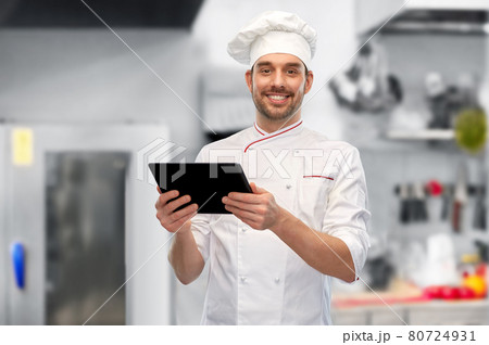 male chef with tablet pc at restaurant kitchen 80724931