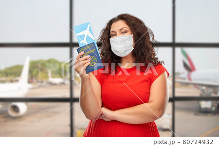 woman in mask with immunity passport and ticket 80724932