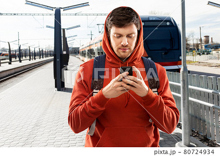 man with smartphone traveling by train 80724934