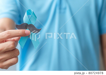November Prostate Cancer Awareness month, Man holding Blue Ribbon with mustache for supporting people living and illness. Healthcare, International men, Father and World cancer day concept 80724978