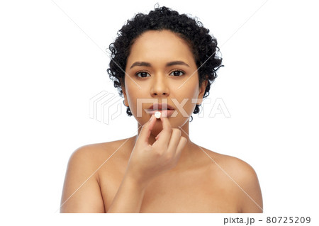 portrait of african american woman taking pill 80725209