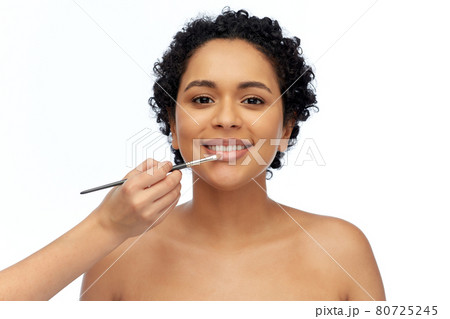 happy woman and hand of make up artist with brush 80725245