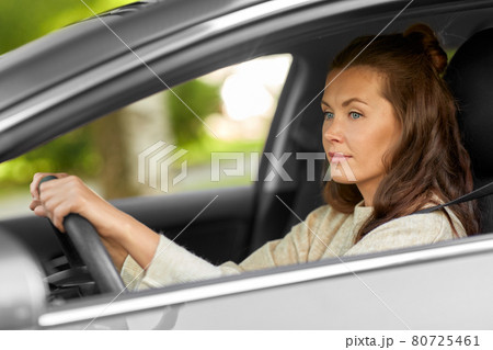 woman or female driver driving car in city woman or female driver driving car in city 80725461