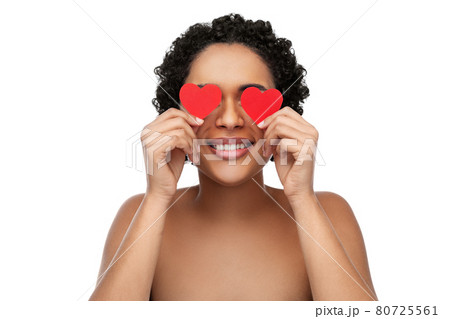 african american woman covering eyes with hearts 80725561