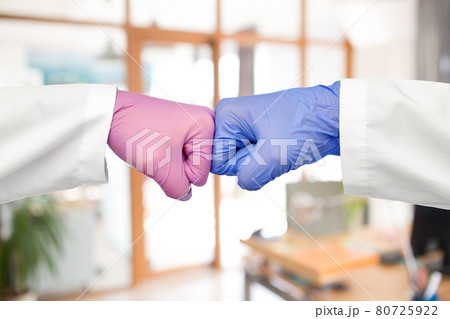 hands of doctors in gloves make fist bump gesture 80725922