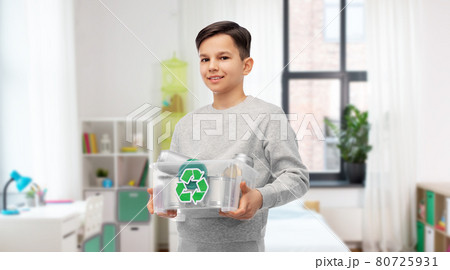 smiling boy sorting metallic waste at home smiling boy sorting metallic waste at home 80725931