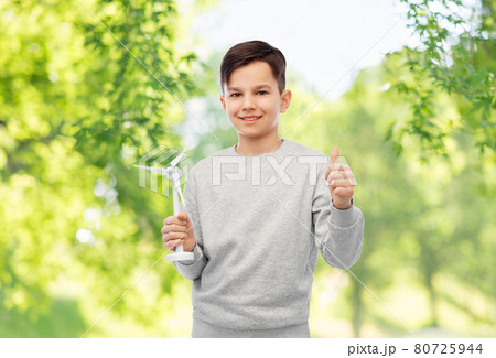 smiling boy with toy wind turbine 80725944