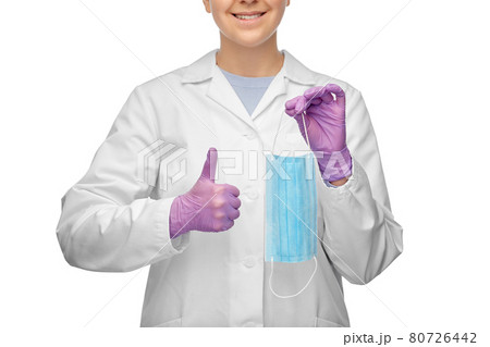 female doctor with medical mask showing thumbs up female doctor with medical mask showing thumbs up 80726442