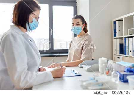 doctor with clipboard and patient at hospital 80726487