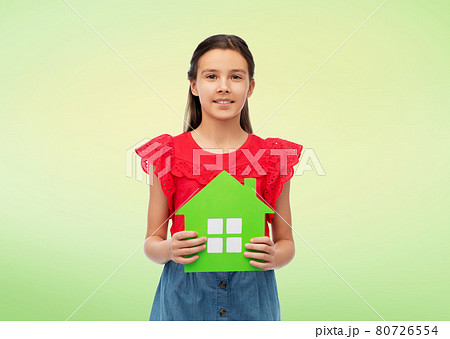 smiling little girl holding green house icon 80726554