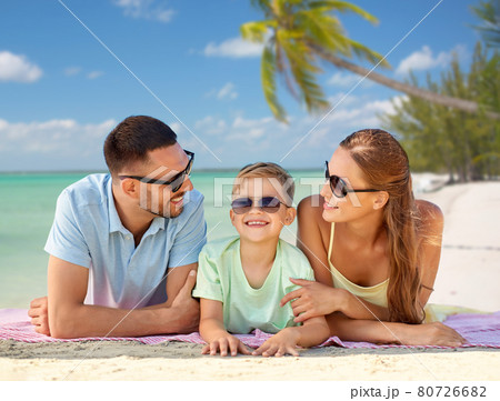 happy family lying over tropical beach background happy family lying over tropical beach background 80726682