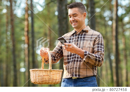 man using smartphone to identify mushroom 80727458
