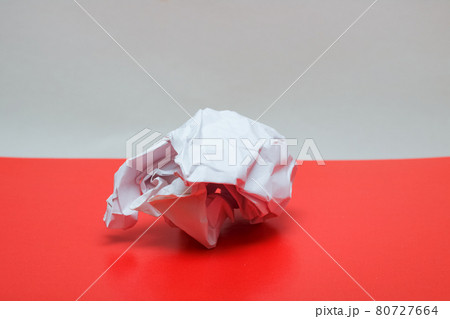 Crumpled paper close up on a red table 80727664